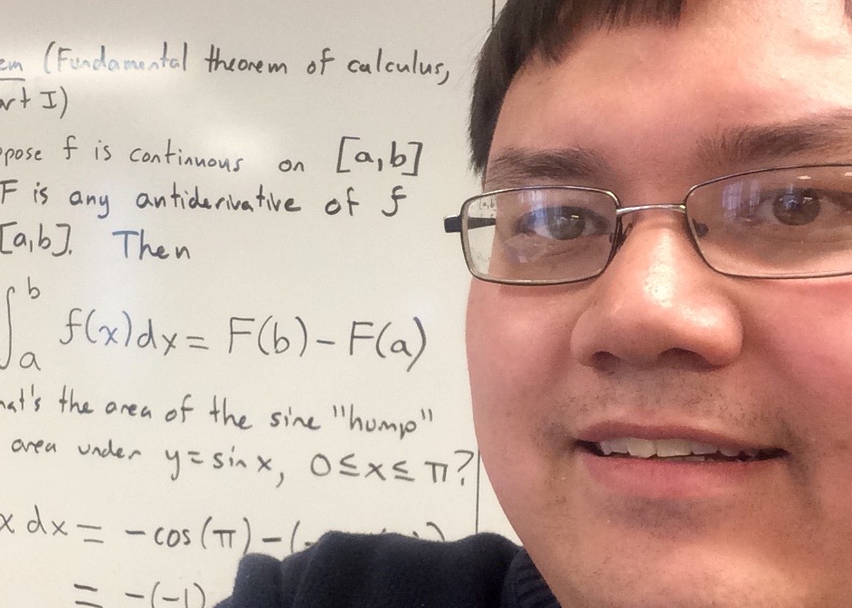 a close-up of my face in front of a whiteboard with calculus