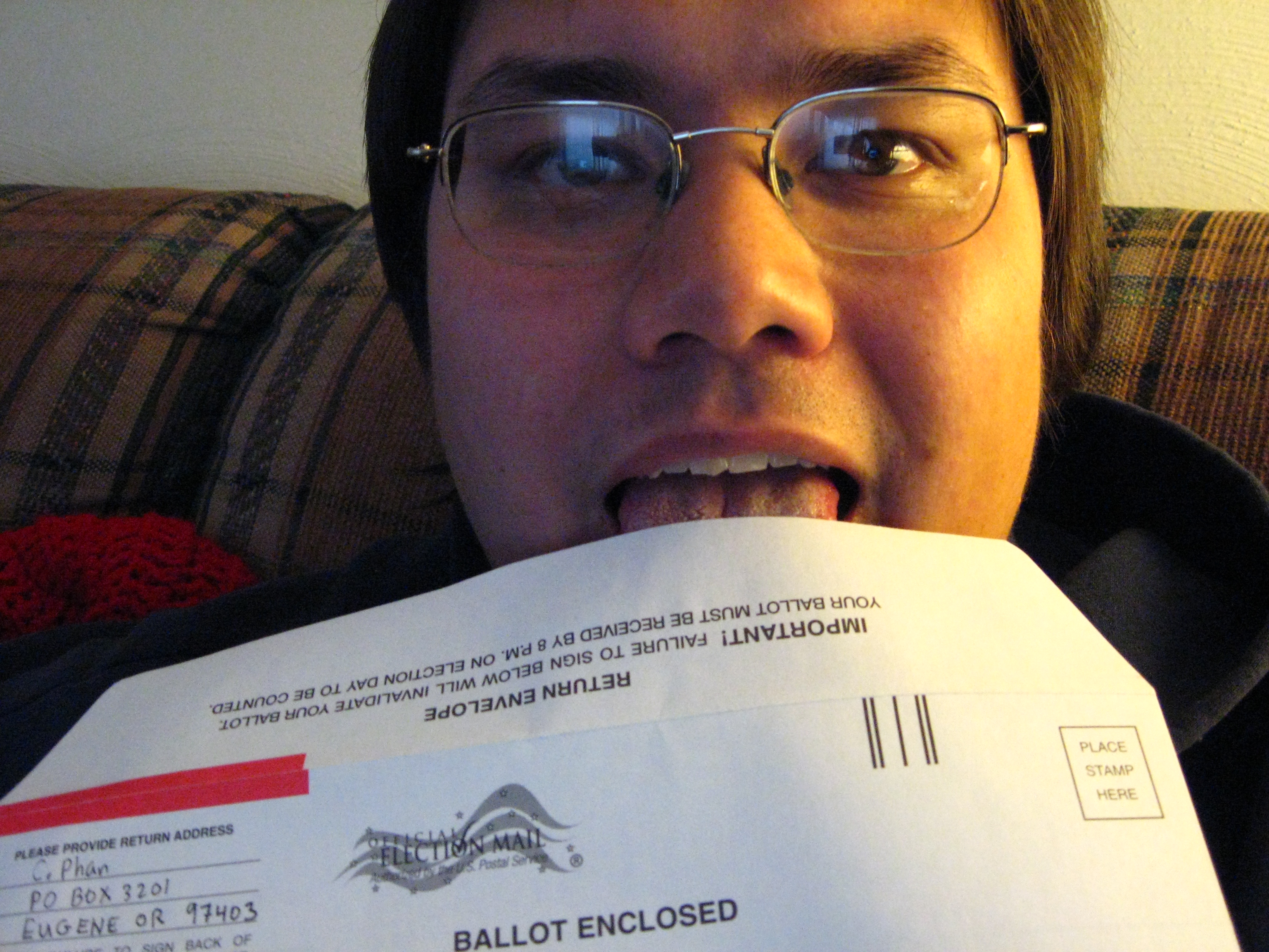 A 27-year-old man licking a mail envelope